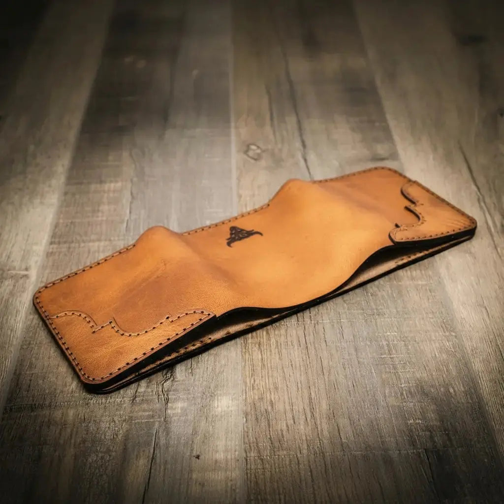 Brown leather western trifold wallet with decorative stitching and a bull emblem.