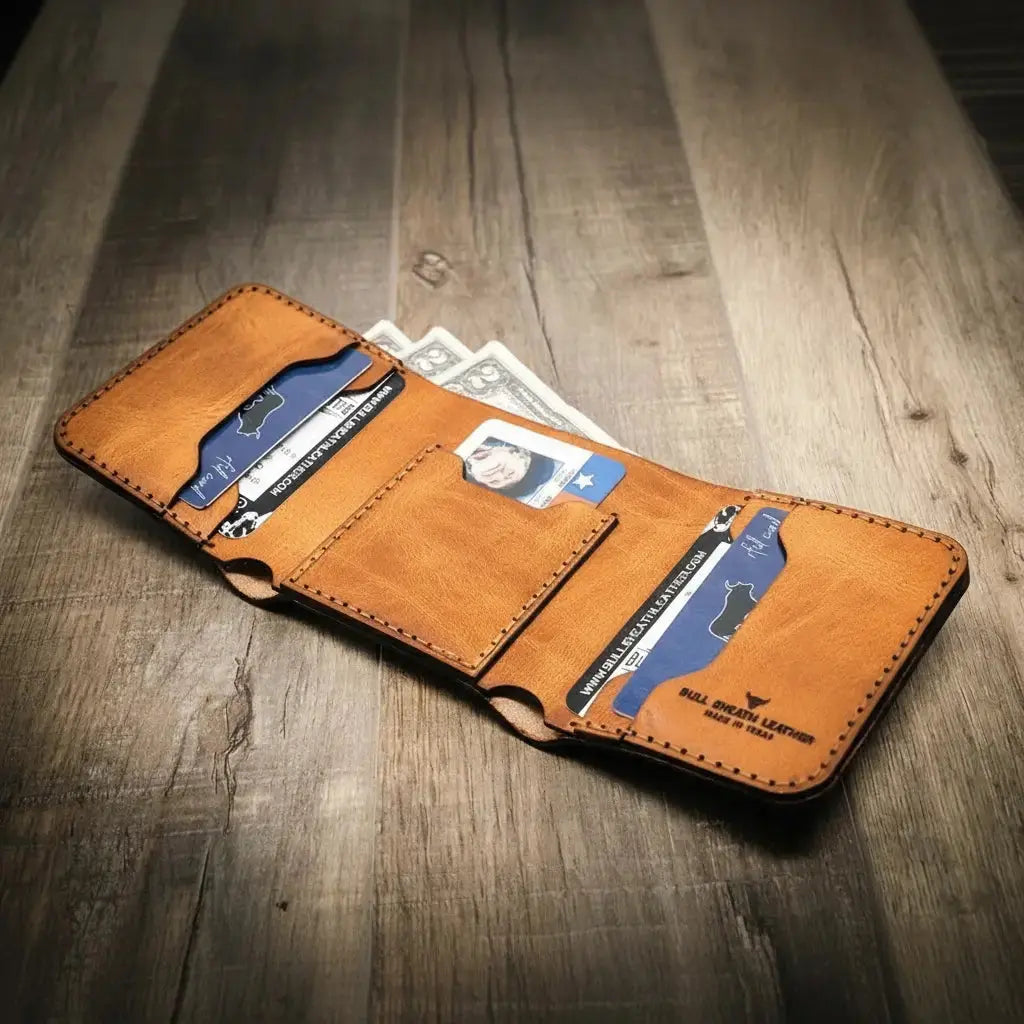 Brown leather trifold wallet with card slots and cash on a wooden surface.
