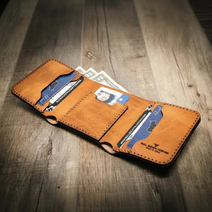 Brown leather trifold wallet with card slots and cash on a wooden surface.