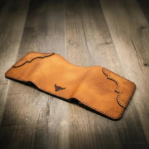 Brown leather trifold wallet with bull logo and decorative stitching