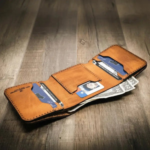 Brown leather trifold wallet open with cards and US dollar bills inside.