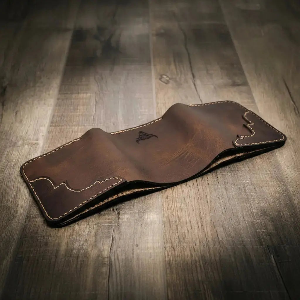 Brown leather trifold wallet with stitched edges and embossed bull logo.