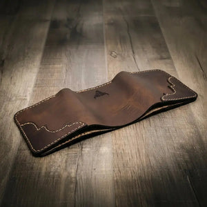 Brown leather trifold wallet with stitched edges and embossed bull logo.