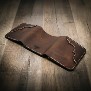 Brown leather trifold wallet with embossed bull logo and contrasting stitching.