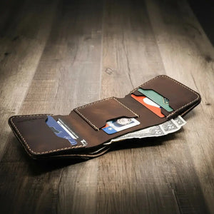 Brown leather trifold wallet with credit cards and US dollar bills