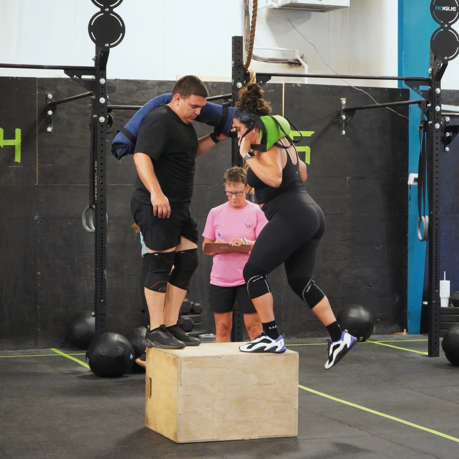 Man and woman using workout battle bag in gym