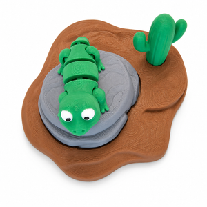 Top view of 3D printed green lizard toy on rock with cactus and desert base by The Tween Space