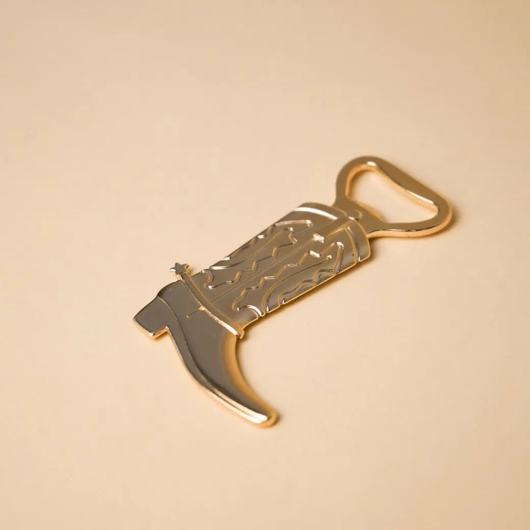 Gold cowboy boot bottle opener with embossed pattern