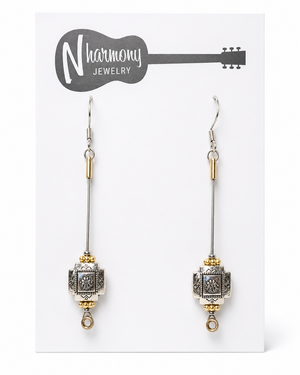 Decorative earrings on a 'N Harmony Jewelry' card with a guitar illustration.