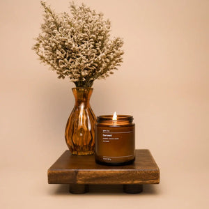 Amber glass harvest soy candle with dried flowers in a vase