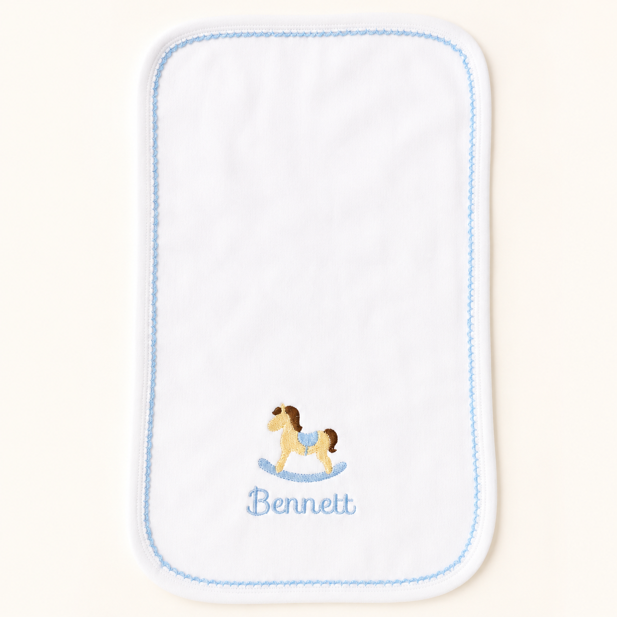 Personalized white baby bib with blue trim