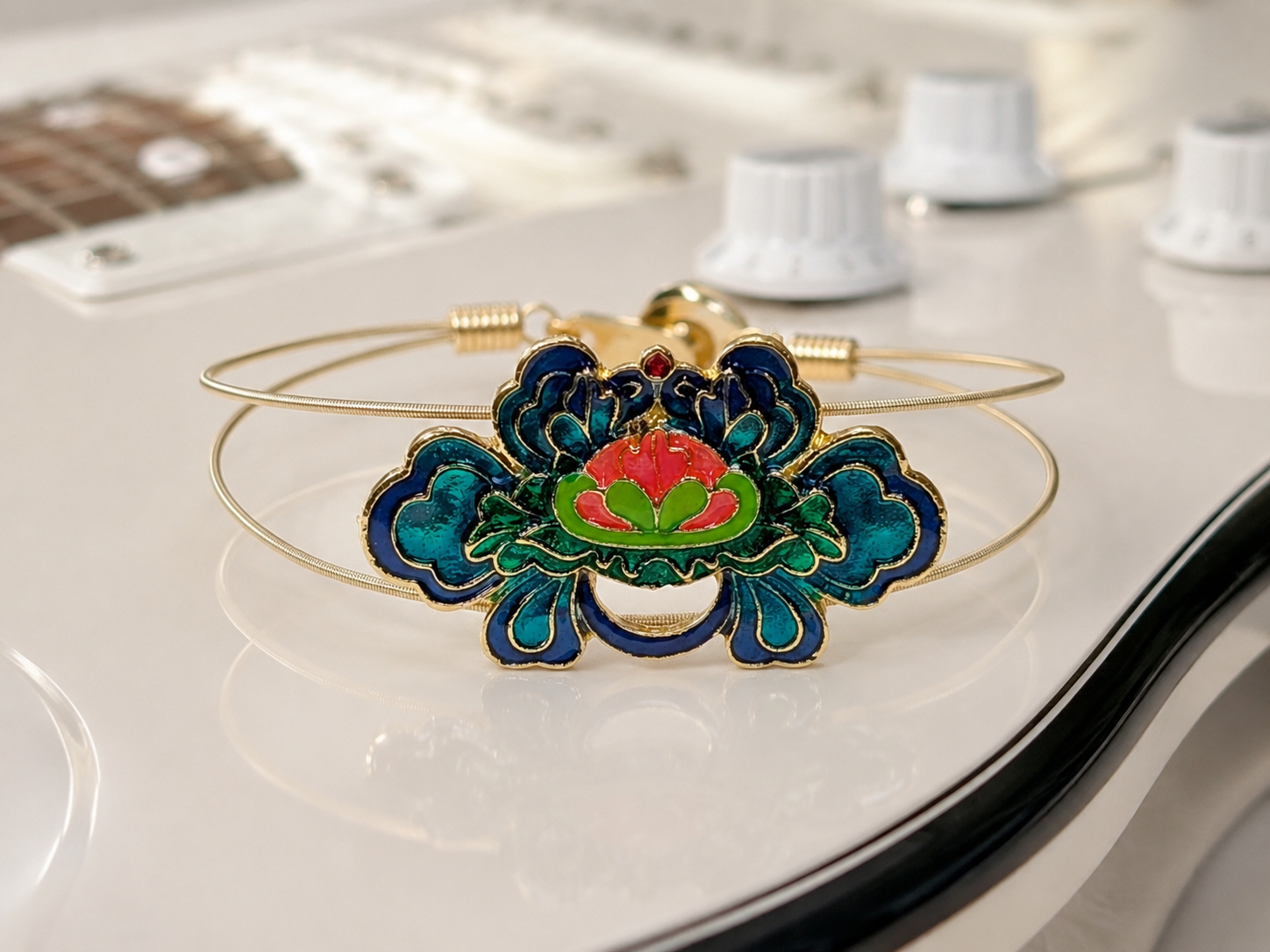 Decorative bracelet with floral design on a guitar
