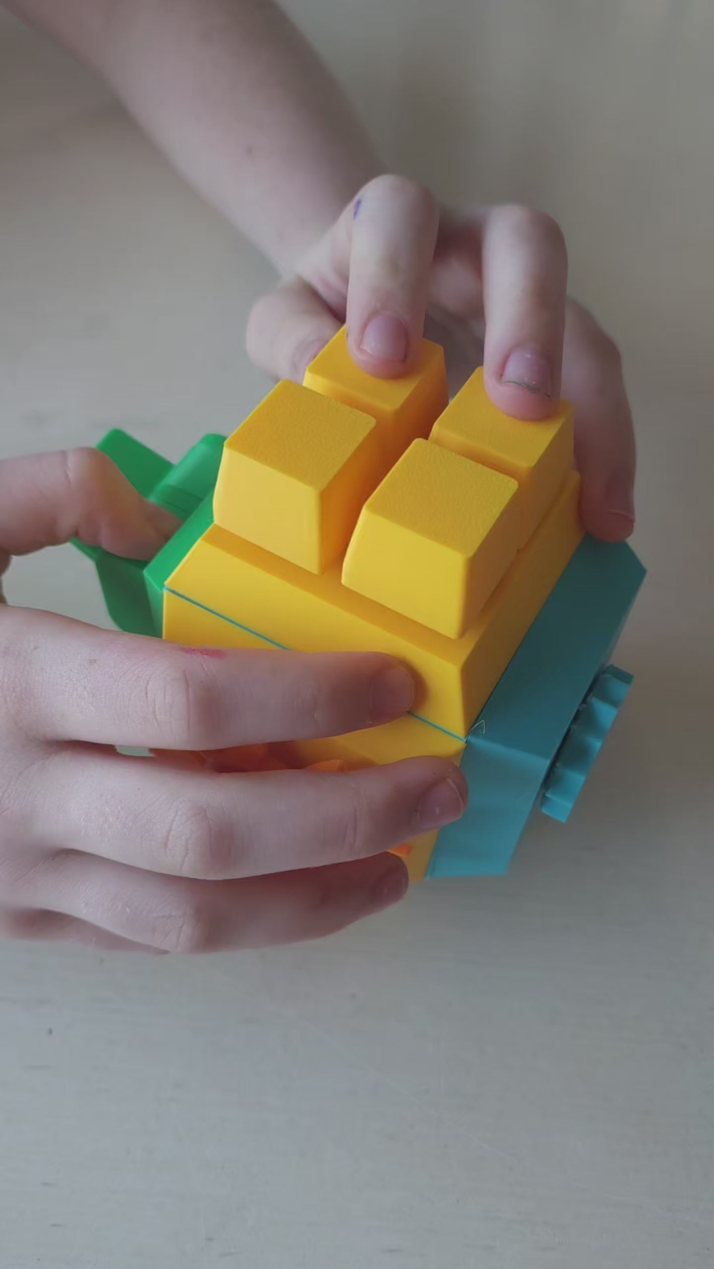 Nora, 12-year-old creator of The Tween Space, holding the modular fidget cube with swappable faces she designed.