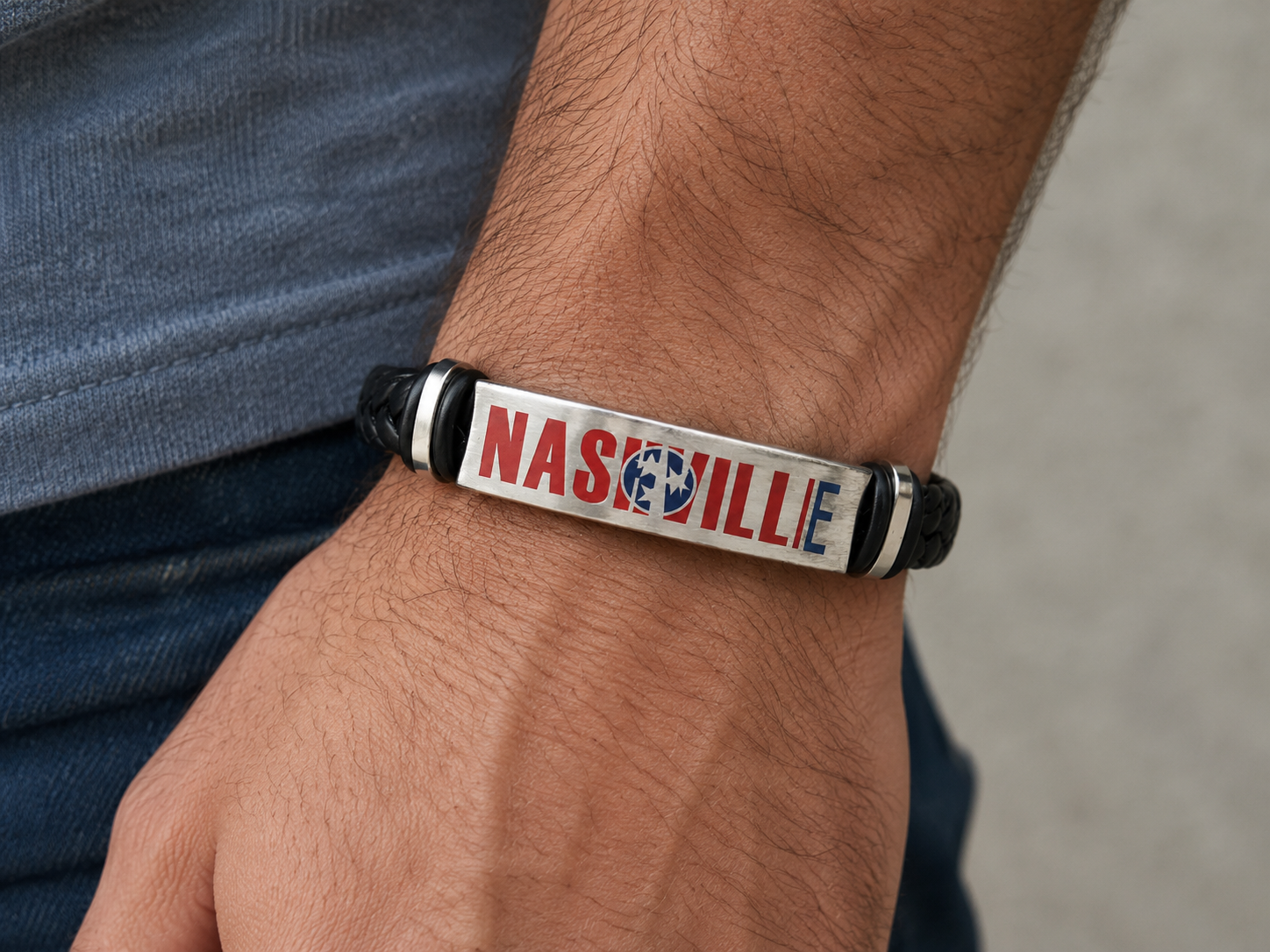 Bracelet with 'Nashville' text on a wrist against a blurred background