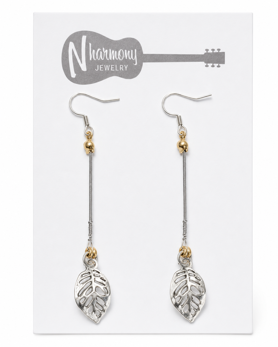 Pair of leaf-shaped earrings on a 'N Harmony Jewelry' card.