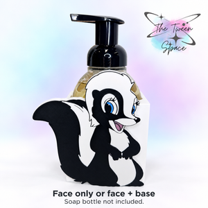 Cute Skunk interchangeable decorative face on a white base, with The Tween Space branding; soap bottle shown for display and not included