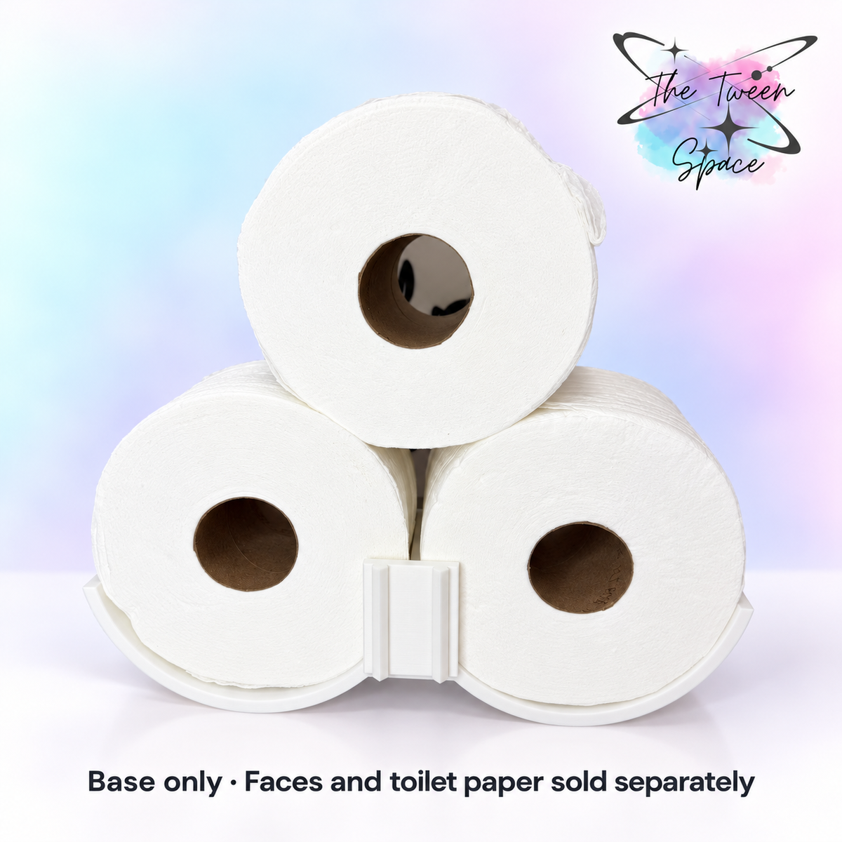 White interchangeable toilet-paper storage base shown with three rolls and an empty front face mount; faces and toilet paper not included