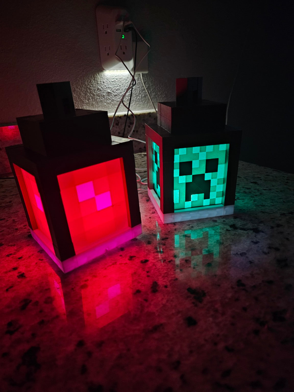 Side view of handmade block style LED lanterns with green and orange light