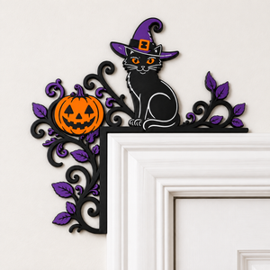 Witch cat and pumpkin Halloween door topper close-up on a white doorframe